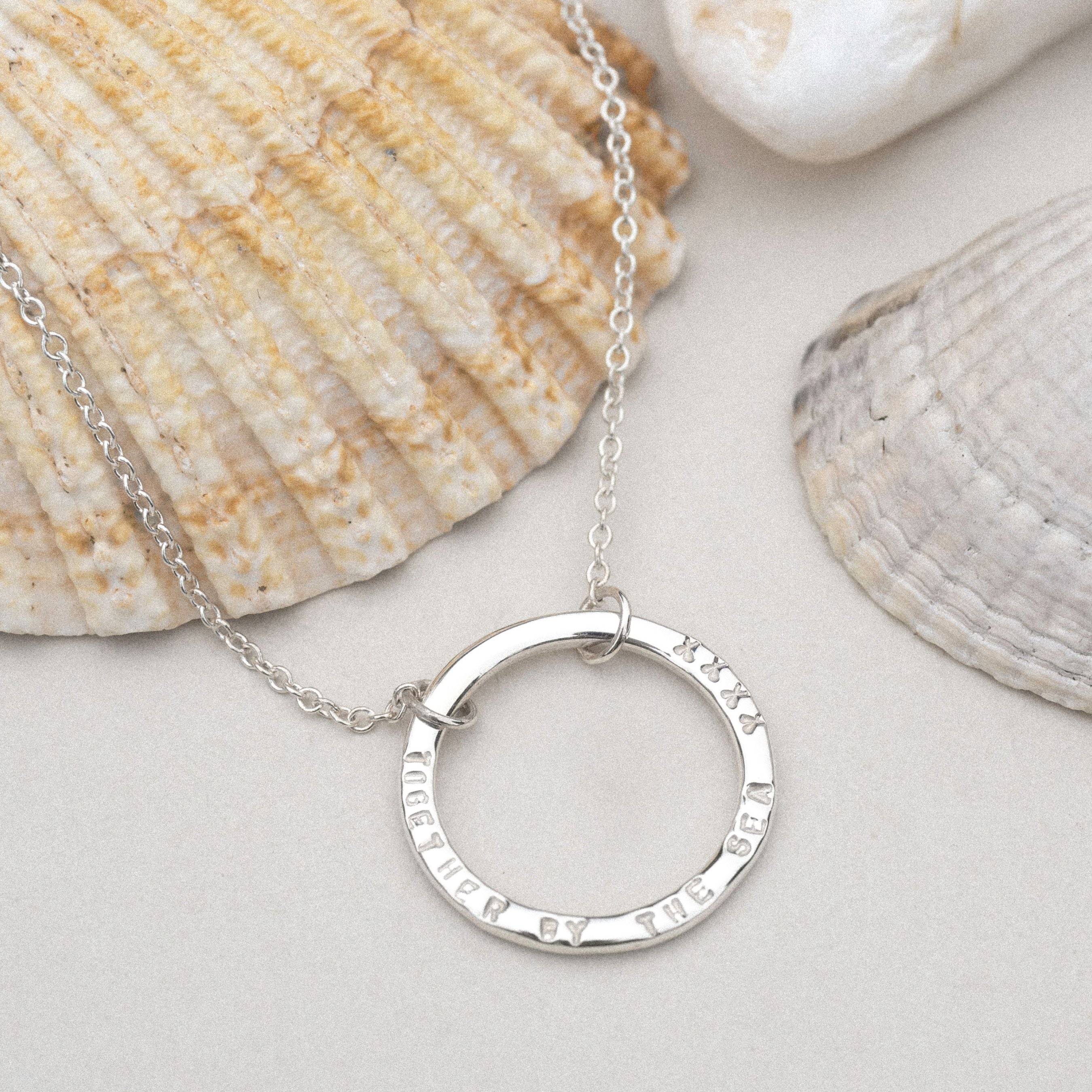 Single halo necklace in sterling silver with custom hand-stamped quote