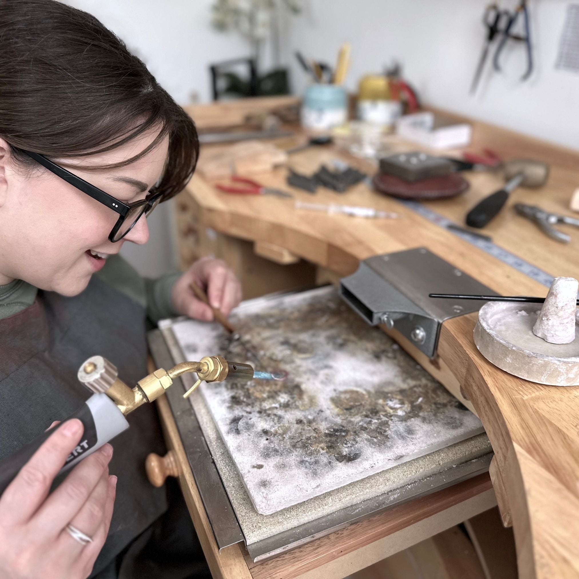 Jeweller handcrafting Organic Initial Stud Earrings in studio, using traditional metalsmithing techniques