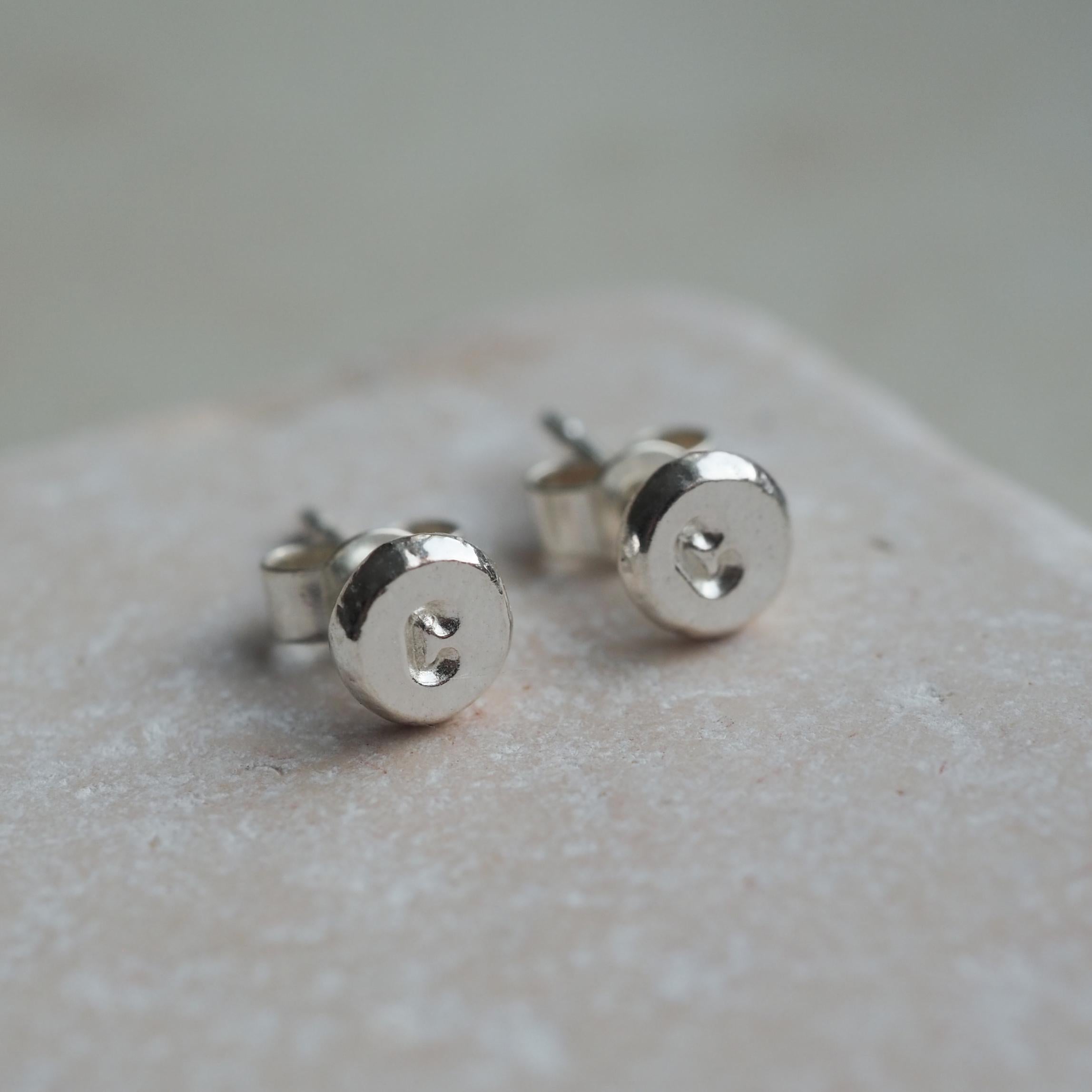 Close-up of Organic Initial Stud Earrings in Sterling Silver, featuring a hand-stamped initial.