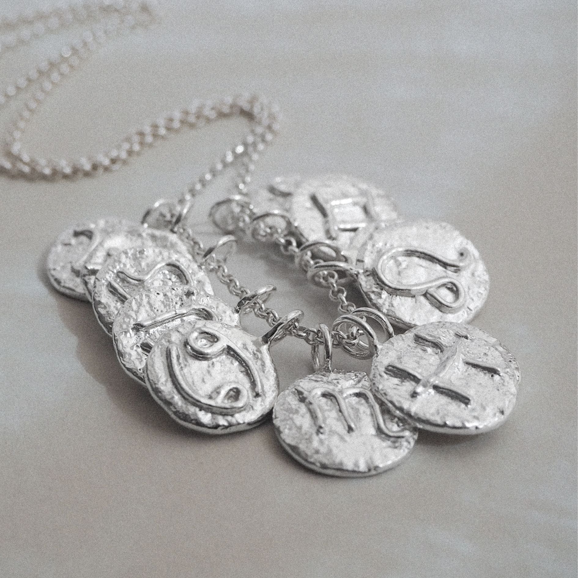 Personalised molten zodiac necklace, sterling silver, with zodiac sign of choice