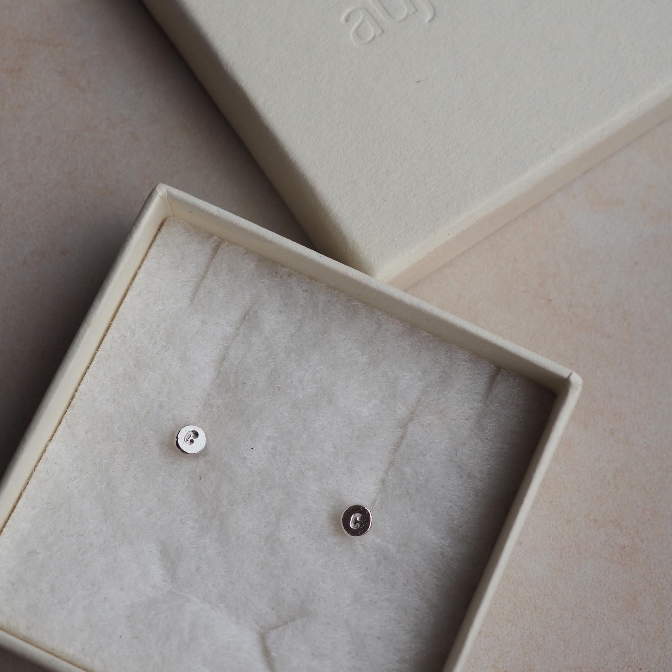 Pair of Organic Initial Stud Earrings in a gift box, showing a subtle and handcrafted design.