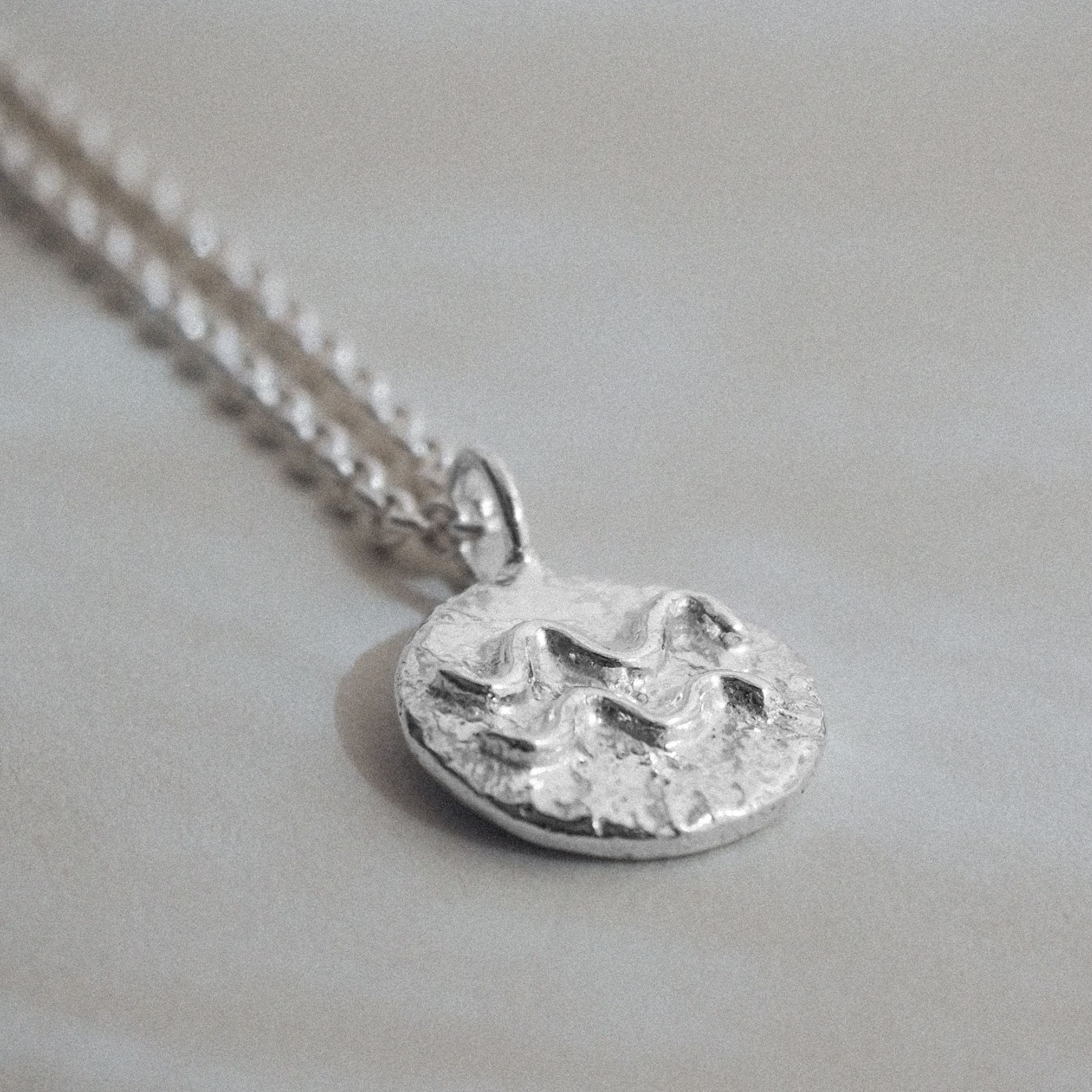 Handmade molten zodiac necklace in sterling silver