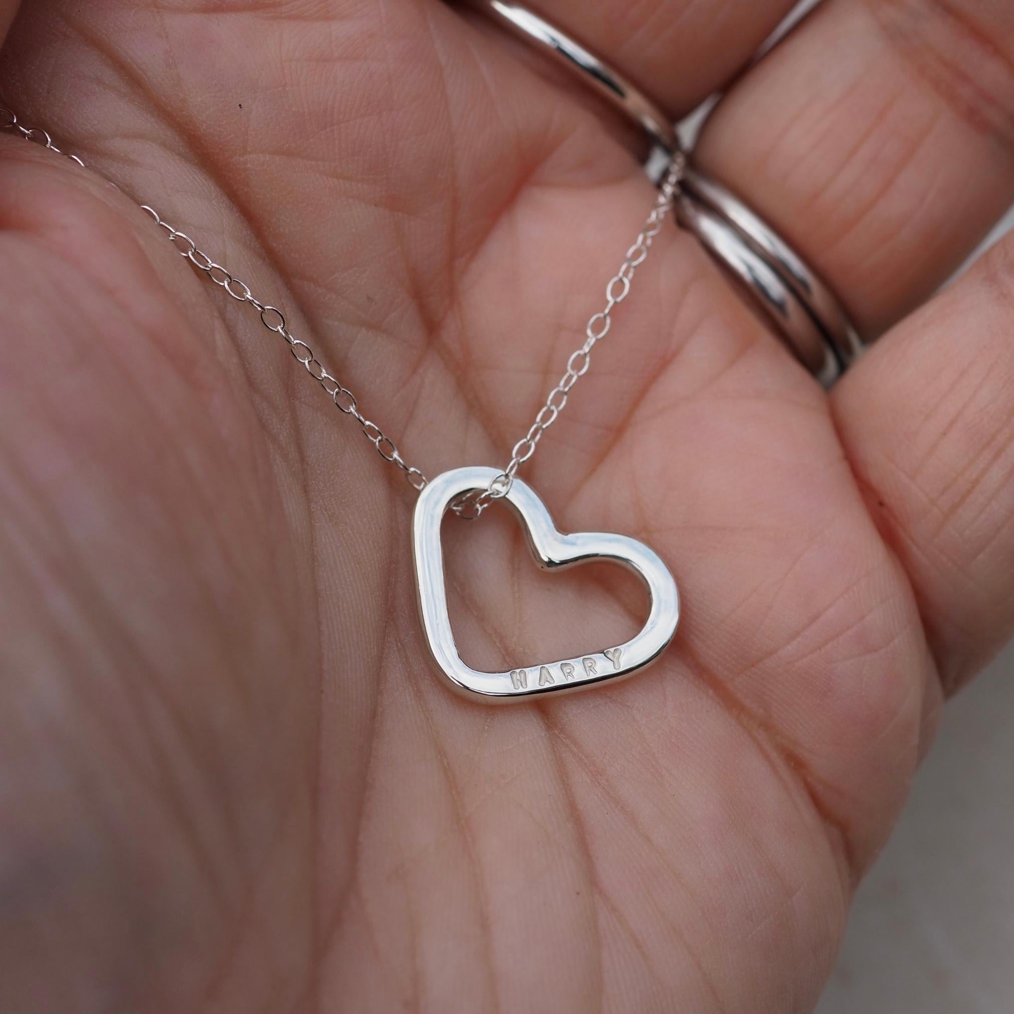 Personalised sterling silver heart charm necklace, hand-stamped with a name