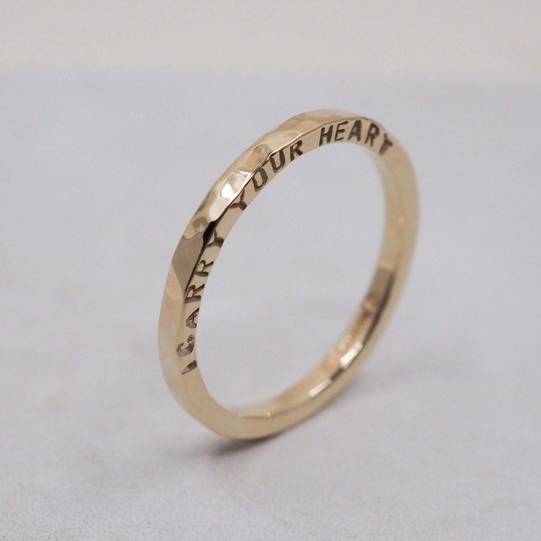 Gold ring personalised with a handstamped quote from a poem