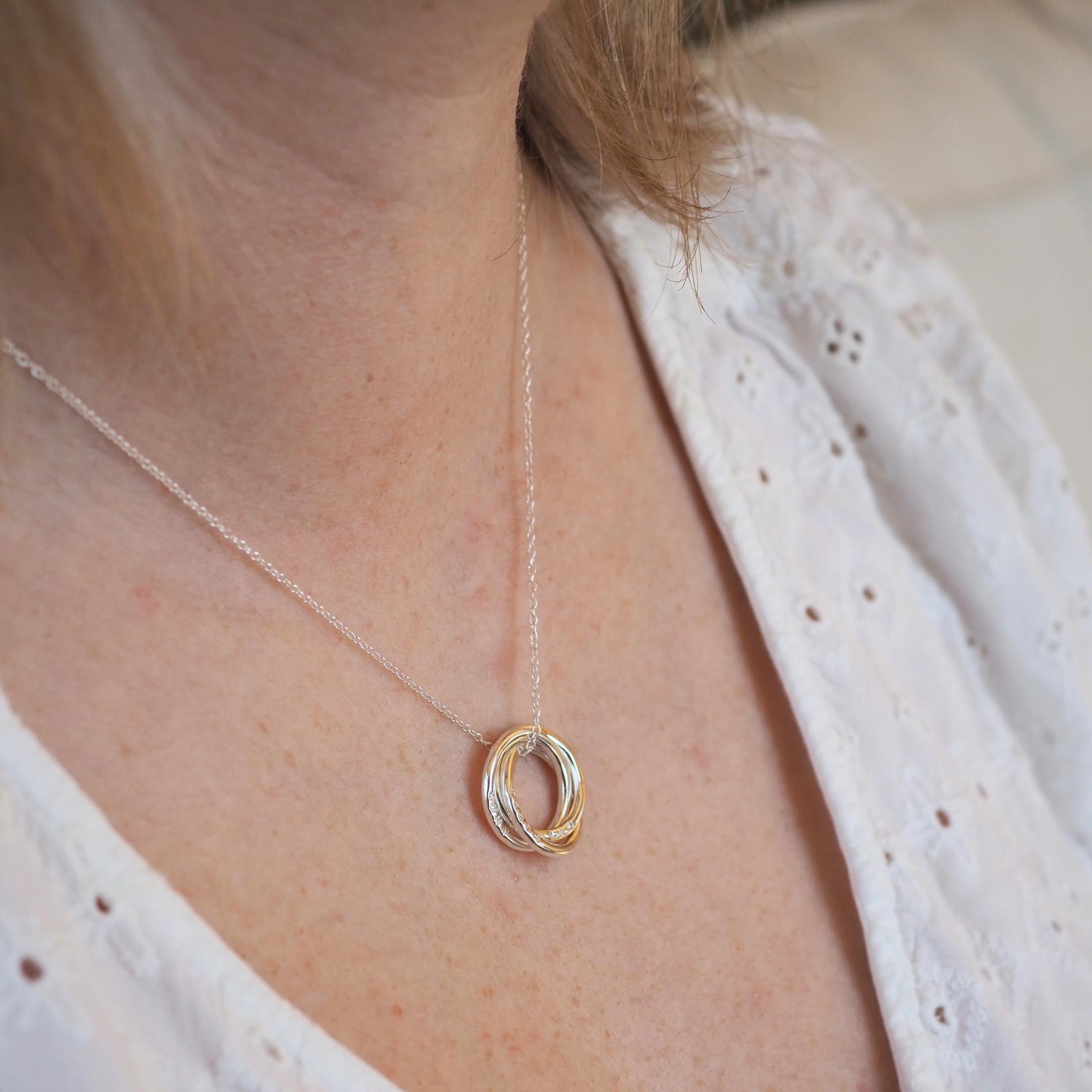 Model wearing an interlocking ring necklace in sterling silver