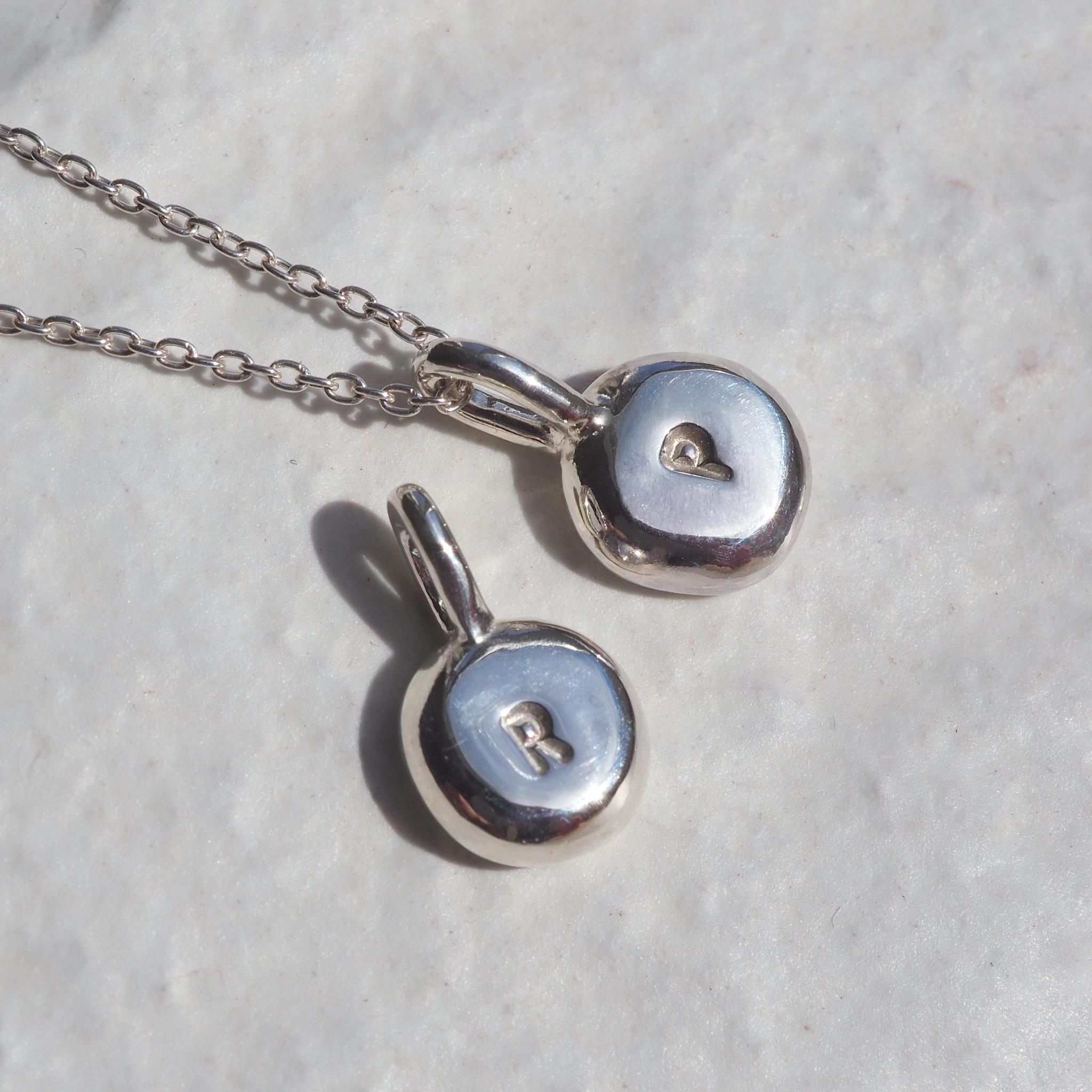 Hand-stamped sterling silver pebble necklace, personalised with initials 